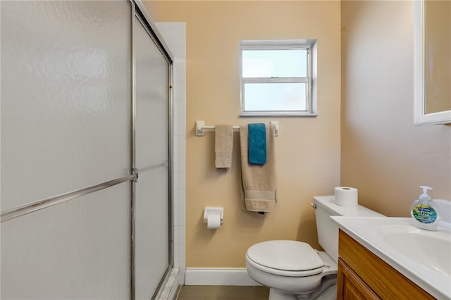 bathroom featuring vanity, walk in shower, and toilet