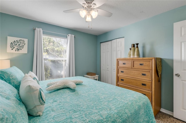 bedroom with ceiling fan, a closet, and a textured ceiling