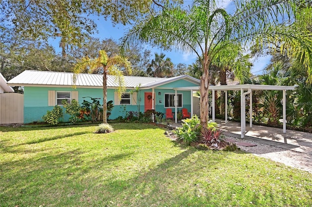 ranch-style house featuring a carport and a front lawn