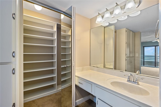 bathroom featuring vanity and ceiling fan