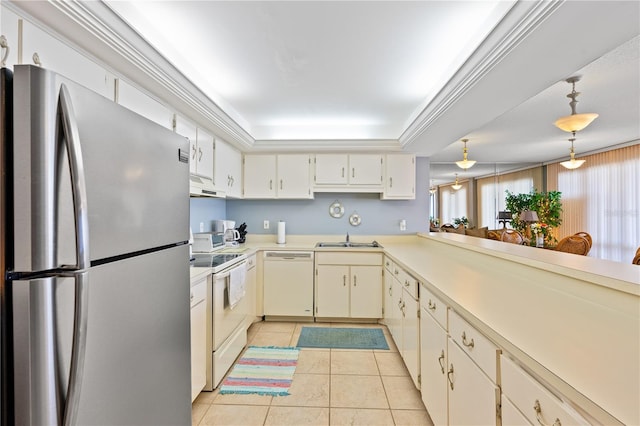 kitchen featuring light tile patterned floors, white appliances, sink, hanging light fixtures, and a tray ceiling