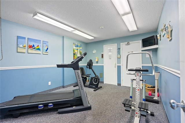 workout room with a textured ceiling