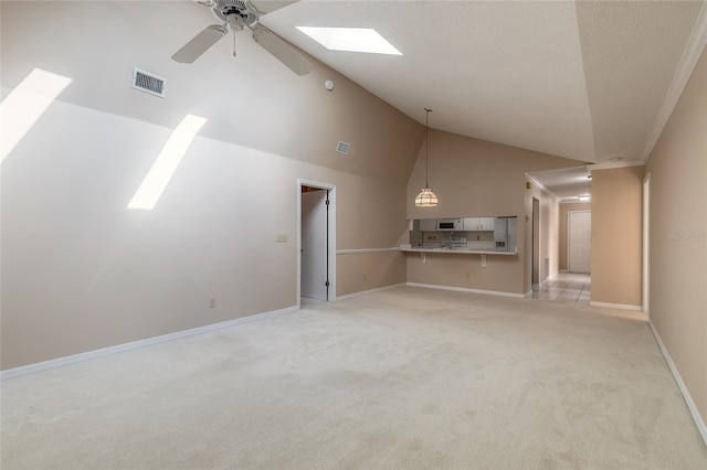 unfurnished living room featuring ceiling fan, light colored carpet, and high vaulted ceiling