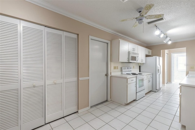 kitchen featuring white cabinetry, light tile patterned floors, white appliances, crown molding, and a textured ceiling