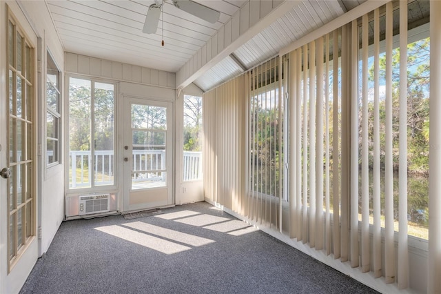 unfurnished sunroom featuring ceiling fan and a healthy amount of sunlight