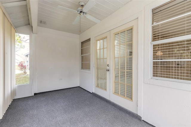 unfurnished sunroom with lofted ceiling with beams, ceiling fan, and french doors