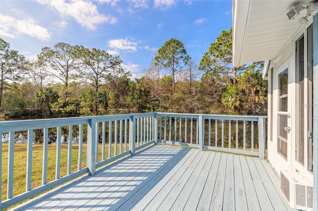 wooden deck featuring a yard