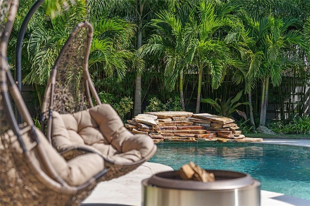 view of swimming pool featuring a fire pit