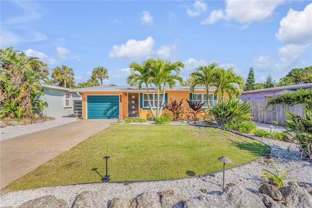 view of front of house with a garage, fence, concrete driveway, and a front yard