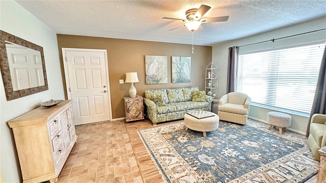 sitting room with a textured ceiling and ceiling fan