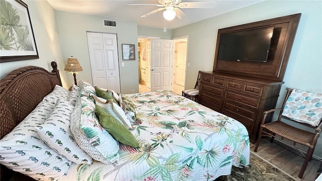 bedroom with hardwood / wood-style floors, a closet, and ceiling fan