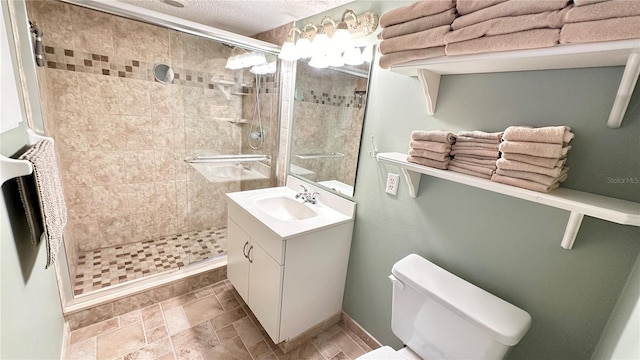 bathroom featuring vanity, a shower with shower door, a textured ceiling, and toilet