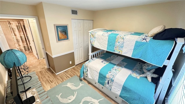 bedroom with hardwood / wood-style floors and a closet