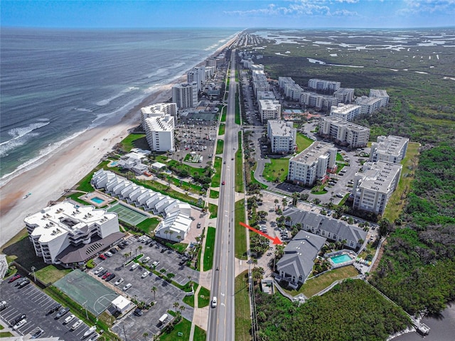 aerial view with a water view and a view of the beach