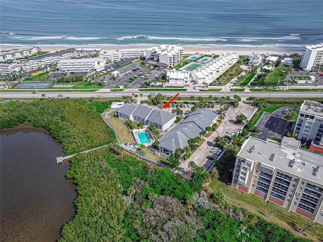 birds eye view of property featuring a view of the beach and a water view