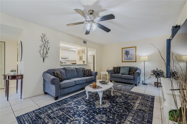 living room with ceiling fan and light tile patterned floors