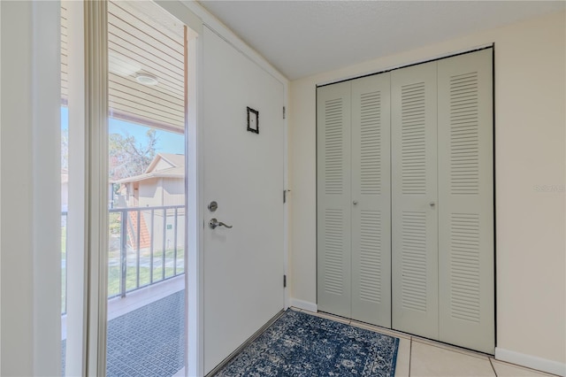 doorway to outside with light tile patterned floors