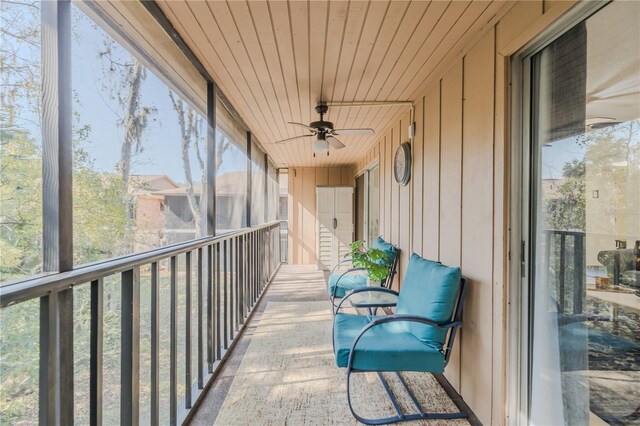 sunroom with ceiling fan and wood ceiling