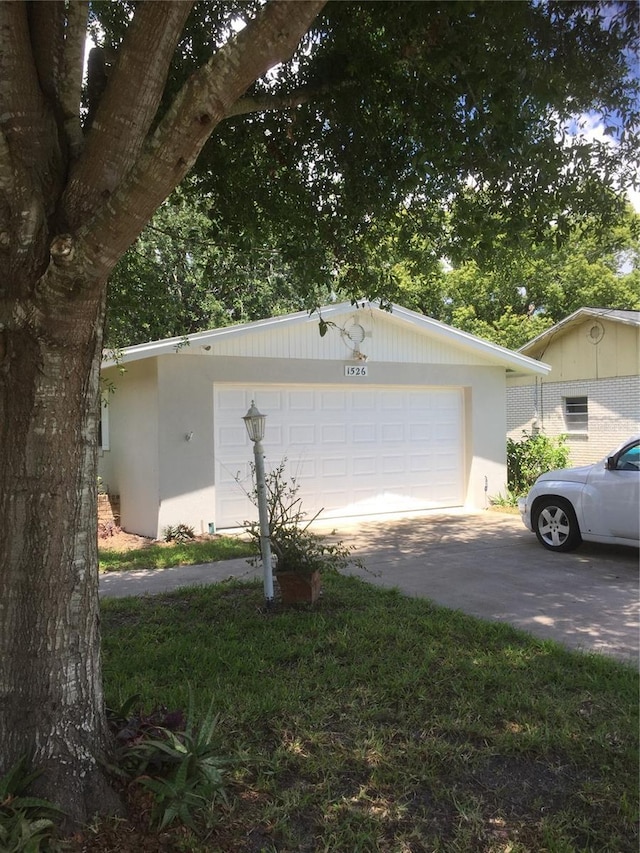 view of front of home with a garage and an outdoor structure