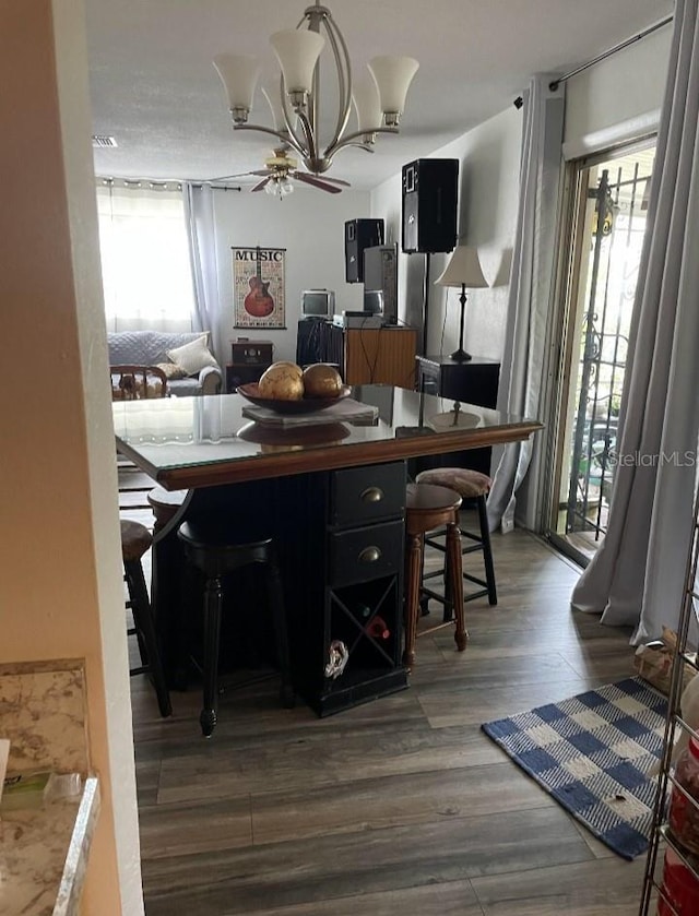 dining room featuring a wealth of natural light, wood finished floors, and a ceiling fan