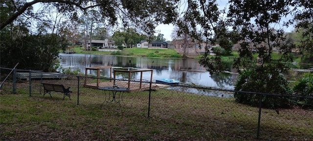 view of dock with fence and a water view