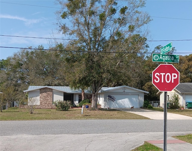 view of front of home with concrete driveway and an attached garage