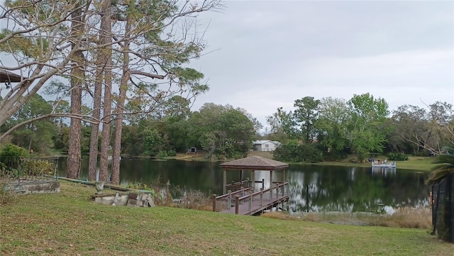 dock area with a yard and a water view