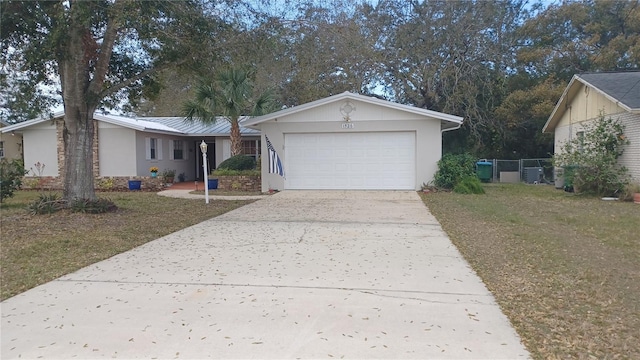 ranch-style home with concrete driveway, central air condition unit, an attached garage, and stucco siding