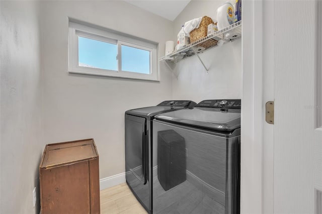 washroom featuring light hardwood / wood-style floors and washing machine and clothes dryer