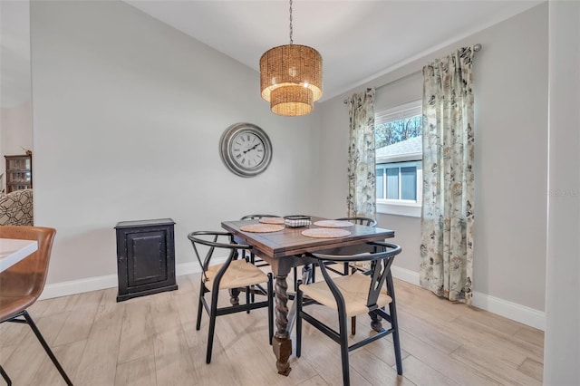 dining space featuring wood finished floors and baseboards