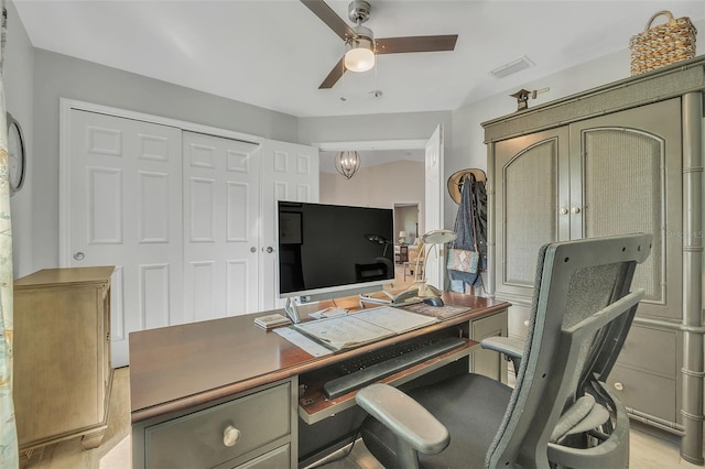 office featuring ceiling fan with notable chandelier