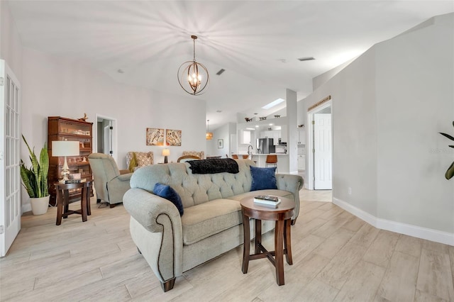 living room featuring an inviting chandelier and light hardwood / wood-style floors