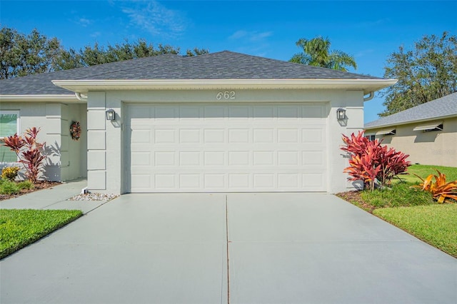 garage featuring concrete driveway