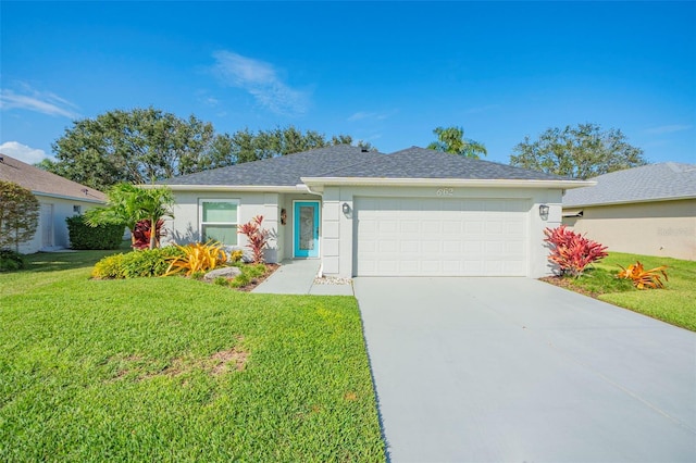 ranch-style home featuring a garage and a front yard