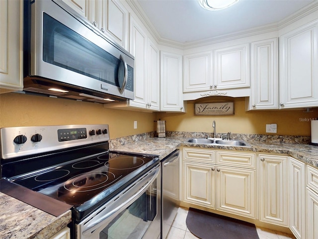 kitchen with white cabinetry, sink, light stone countertops, and appliances with stainless steel finishes