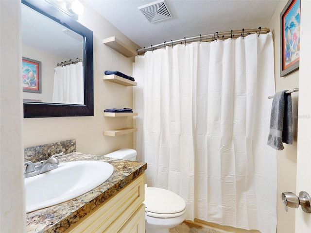 bathroom with vanity, curtained shower, and toilet