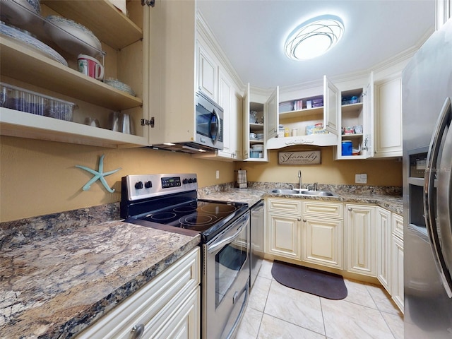 kitchen featuring stainless steel appliances, sink, and dark stone counters