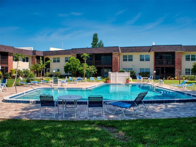 view of pool with a yard and a patio area