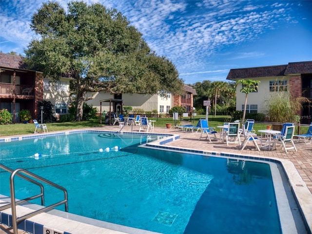 view of pool featuring a patio and a lawn