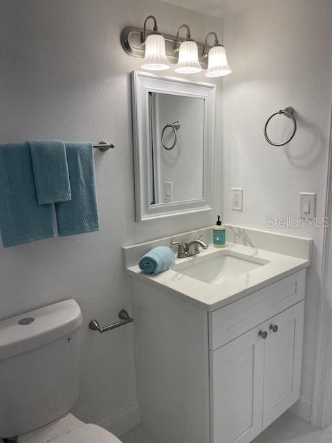 bathroom featuring vanity and toilet