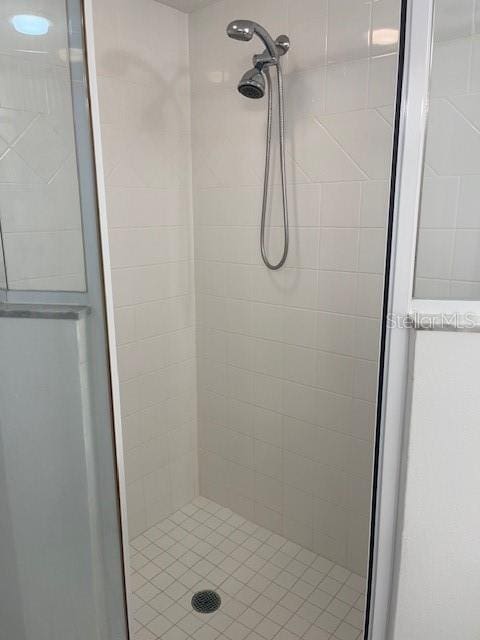 bathroom featuring a shower with door