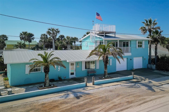 view of front facade featuring a balcony and a garage