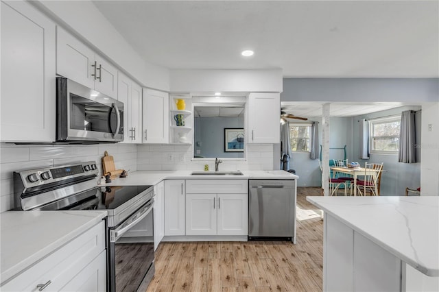 kitchen with white cabinetry, sink, and stainless steel appliances