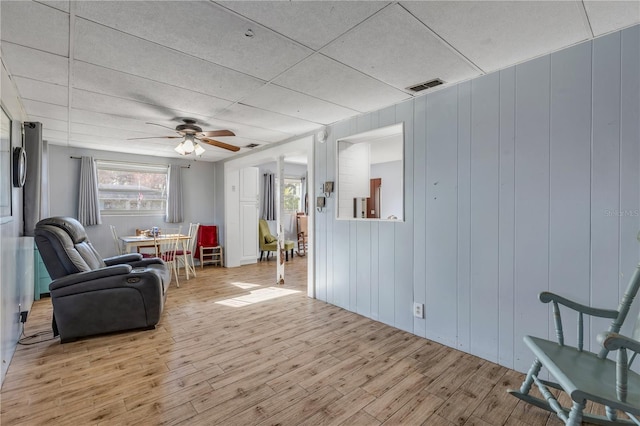 sitting room featuring ceiling fan and light wood-type flooring