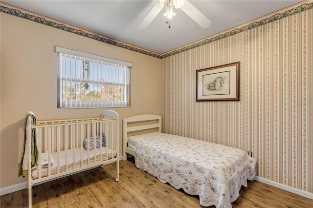 bedroom with hardwood / wood-style flooring and ceiling fan