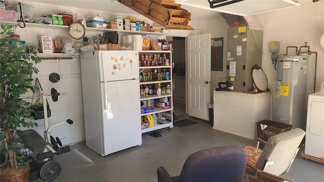 kitchen with water heater, white fridge, heating unit, and washer / dryer