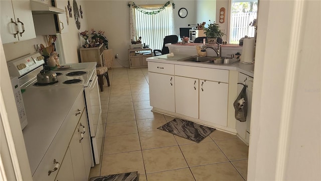 kitchen with white electric stove, white cabinetry, sink, and light tile patterned floors