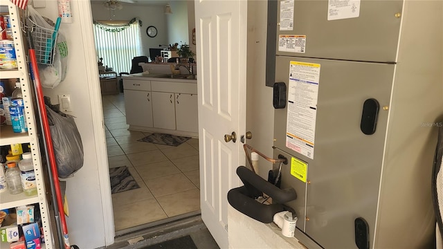 utility room featuring sink and heating unit