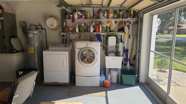 clothes washing area featuring water heater, separate washer and dryer, and heating unit