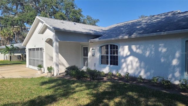 view of home's exterior with a garage and a yard